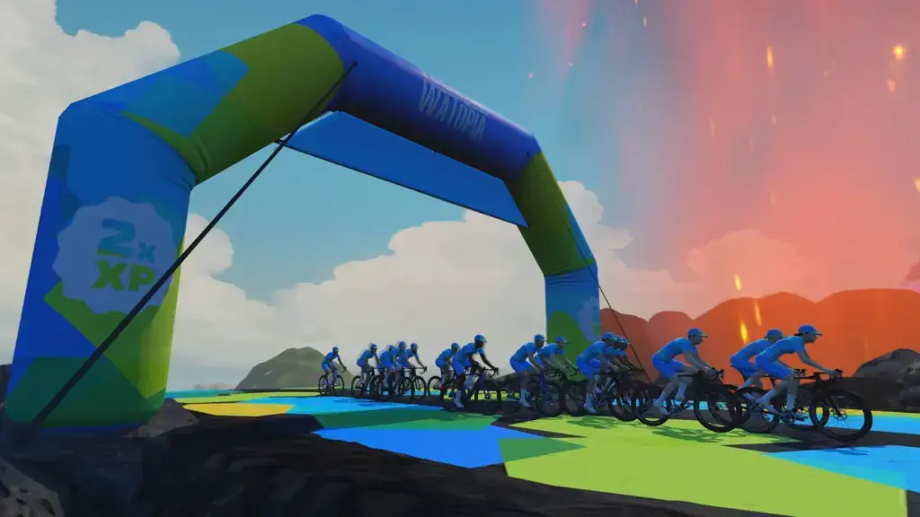 Gruppo di avatar nel Tour of Watopia 2026 sotto l’arco ufficiale 2x XP